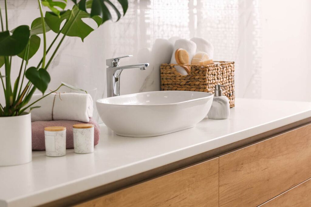 stylish vessel sink on light countertop in modern bathroom